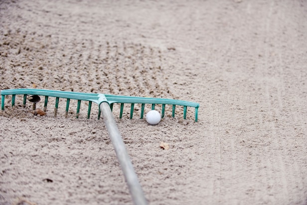 I carefully tried to pick up a rake but I accidentally moved my ball. Is that a penalty? – Australian Golf Digest