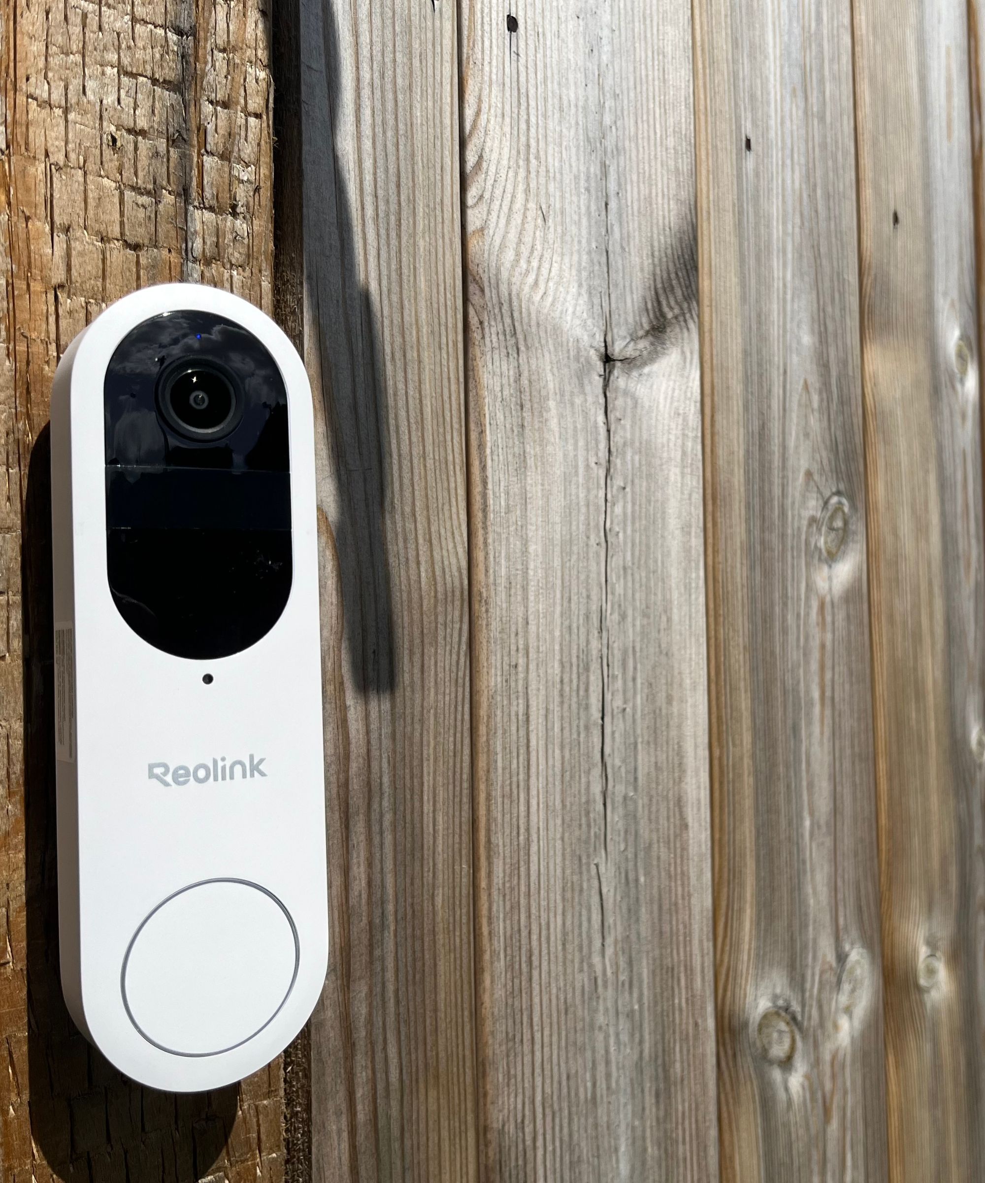 Reolink video doorbell (battery) mounted on a wooden fence