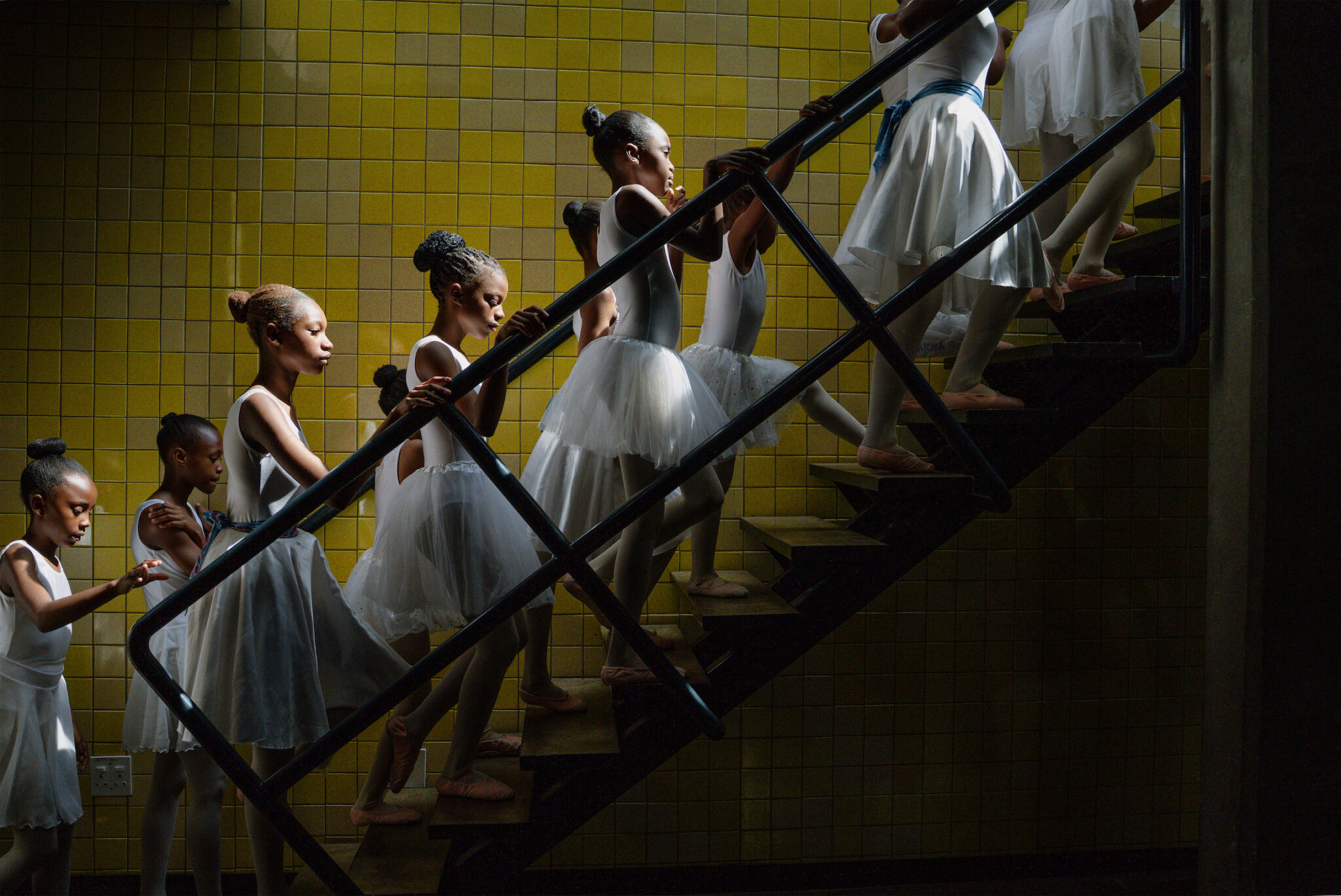 Ihsaan Haffejee, “Joburg Ballet School,” for GroundUp. Young dancers from the Joburg Ballet School backstage at the Soweto Theatre during their year-end performance. Soweto, South Africa, December 7, 2025.