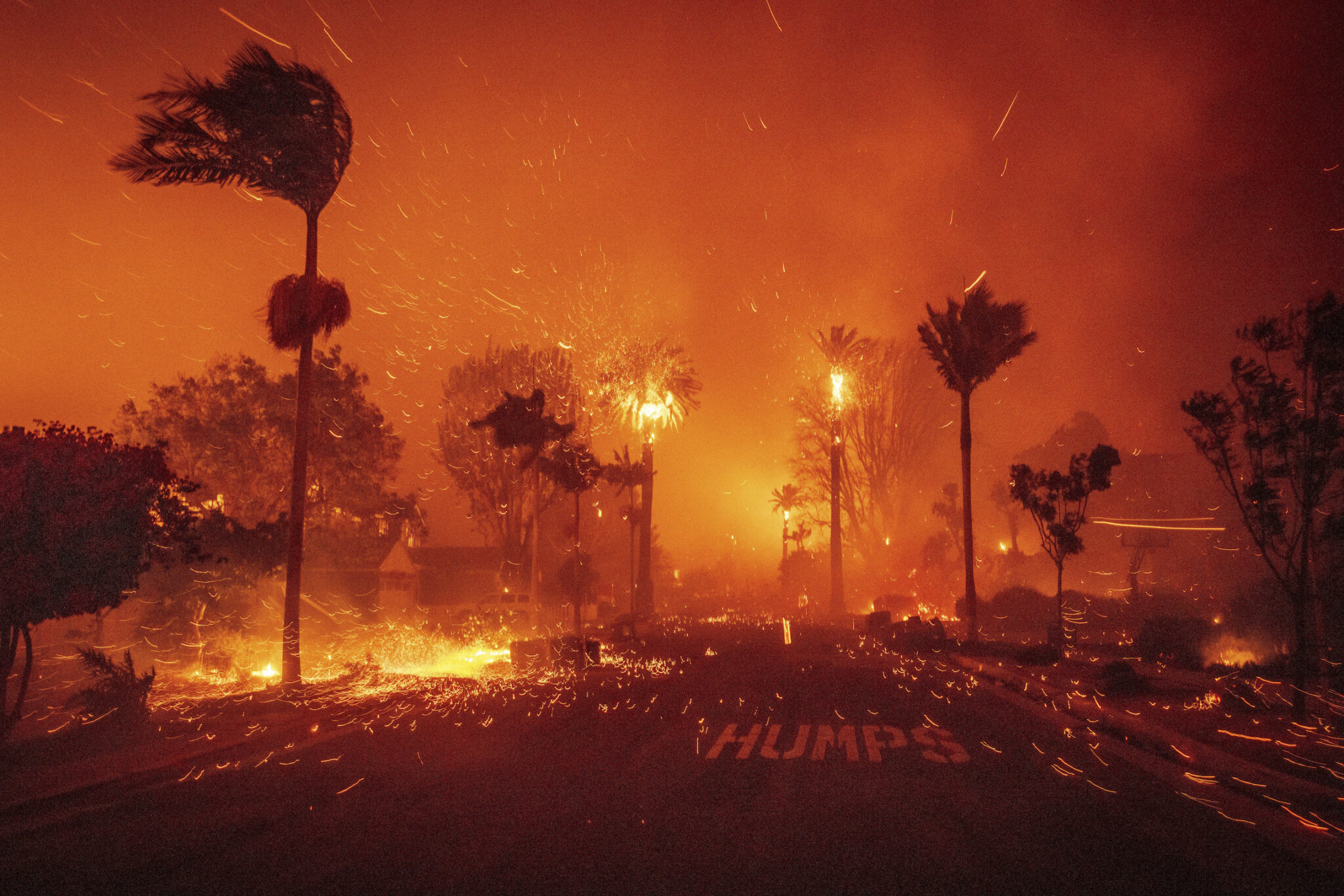 Ethan Swope, “Los Angeles on Fire,” for the Associated Press. The Palisades Fire ravages a neighborhood amid high winds. The Los Angeles blazes inflicted between $28 and $53.8 billion in property damage, disrupting thousands of local businesses. Los Angeles, Calif., January 7, 2025.