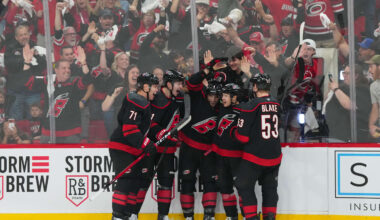 Apr 18, 2026; Raleigh, North Carolina, USA; Carolina Hurricanes left wing Taylor Hall (71) is congratulated by defenseman Alexander Nikishin (21)  defenseman Shayne Gostisbehere (4) center Logan Stankoven (22) and  right wing Jackson Blake (53) after his goal against the Ottawa Senators during the third period in game one of the first round of the 2026 Stanley Cup Playoffs at Lenovo Center. Mandatory Credit: James Guillory-Imagn Images