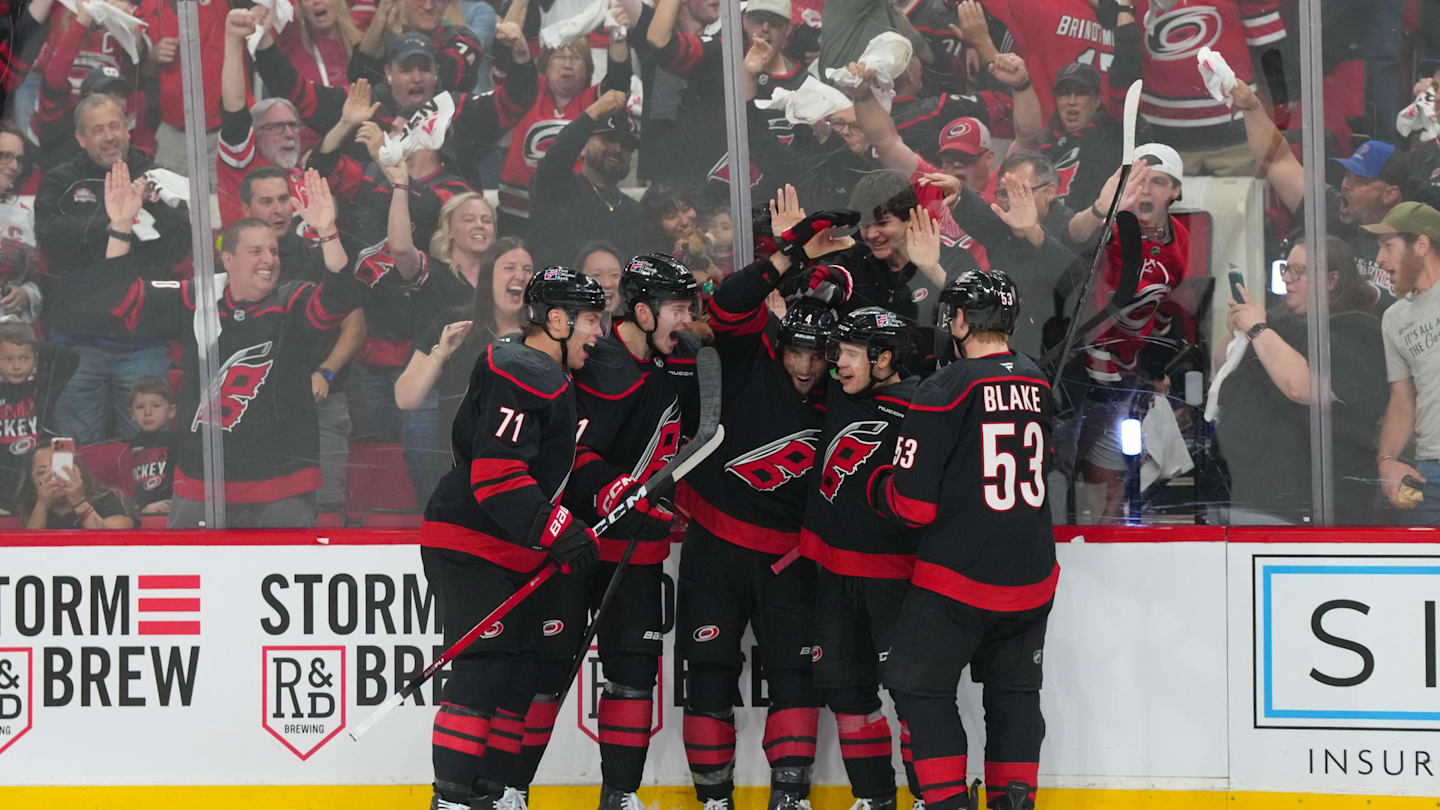 Apr 18, 2026; Raleigh, North Carolina, USA; Carolina Hurricanes left wing Taylor Hall (71) is congratulated by defenseman Alexander Nikishin (21)  defenseman Shayne Gostisbehere (4) center Logan Stankoven (22) and  right wing Jackson Blake (53) after his goal against the Ottawa Senators during the third period in game one of the first round of the 2026 Stanley Cup Playoffs at Lenovo Center. Mandatory Credit: James Guillory-Imagn Images