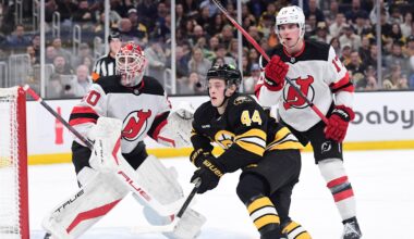 Apr 14, 2026; Boston, Massachusetts, USA; New Jersey Devils goalie Nico Daws (50) looks on as defenseman Simon Nemec (17) and Boston Bruins forward James hagen (44) go after the puck during the first period at TD Garden. Mandatory Credit: Bob DeChiara-Imagn Images
