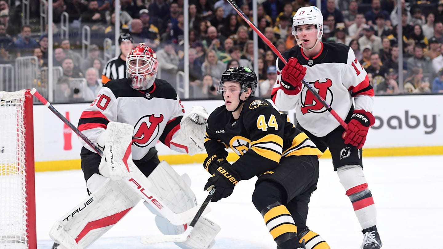 Apr 14, 2026; Boston, Massachusetts, USA; New Jersey Devils goalie Nico Daws (50) looks on as defenseman Simon Nemec (17) and Boston Bruins forward James hagen (44) go after the puck during the first period at TD Garden. Mandatory Credit: Bob DeChiara-Imagn Images