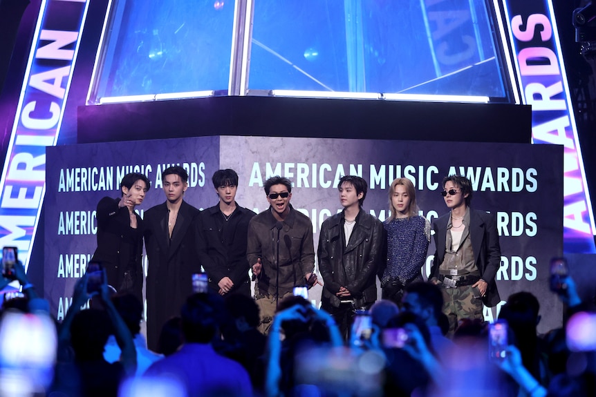 BTS stand on a stage.
