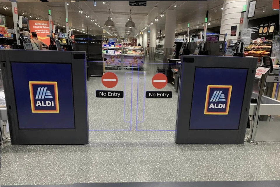 Photo of a gate taken from outside the store with posted signage what reads, "no entry." Source: Supplied