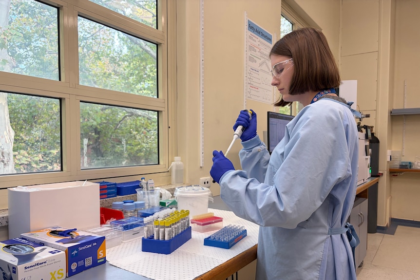 Woman in a pathology lab playing with equipment