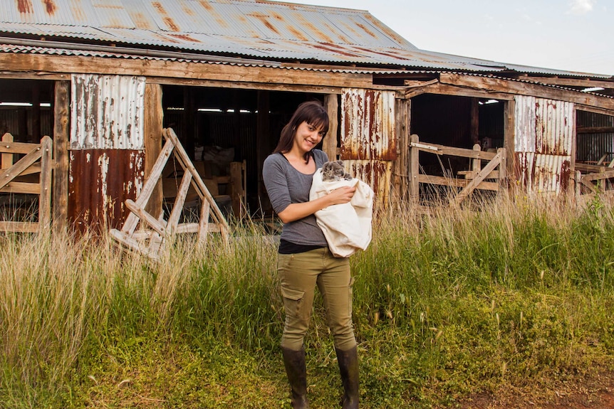 A woman holding a koala.