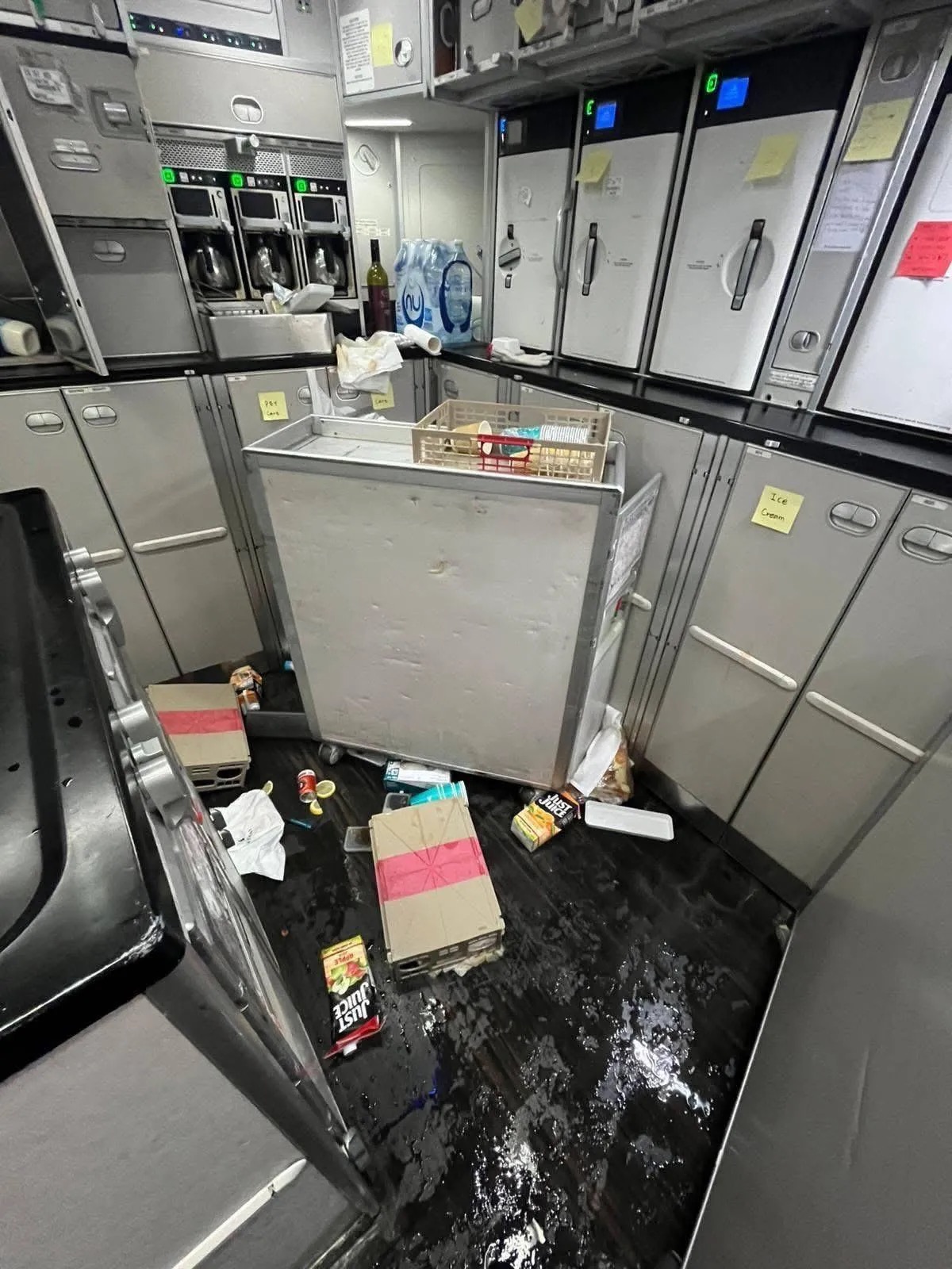 Items like juice tetra packs, liquid and other food items strewn on the ground.