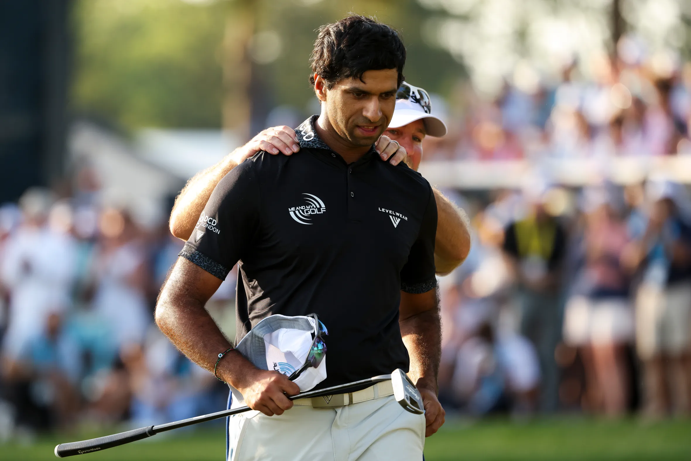 Aaron Rai of England being comforted on the 18th green during the PGA Championship.