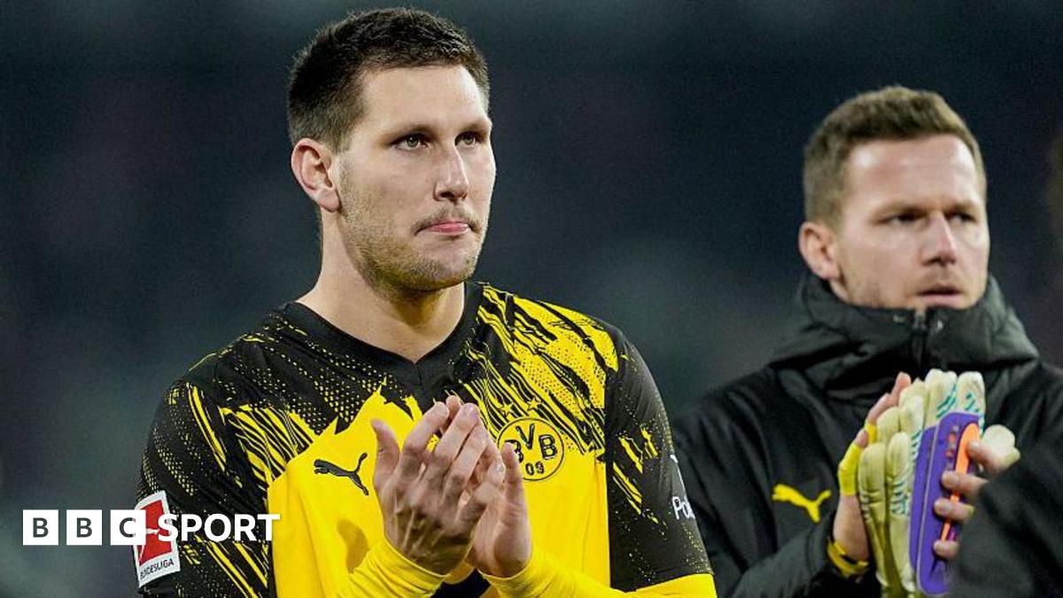 Niklas Sule applauds the Borussia Dortmund fans after their Bundesliga draw at Freiburg in December 2025