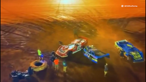 Greg Martin (blue car) was arrested and charged with aggravated assault after he used his car to ram a rival's after an on-track incident in the USA.