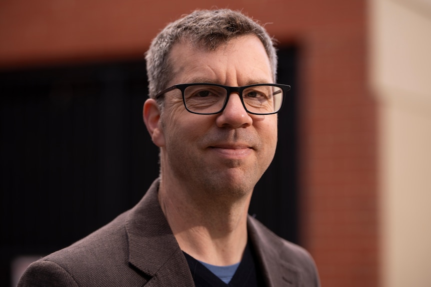 An academic looks at the camera.