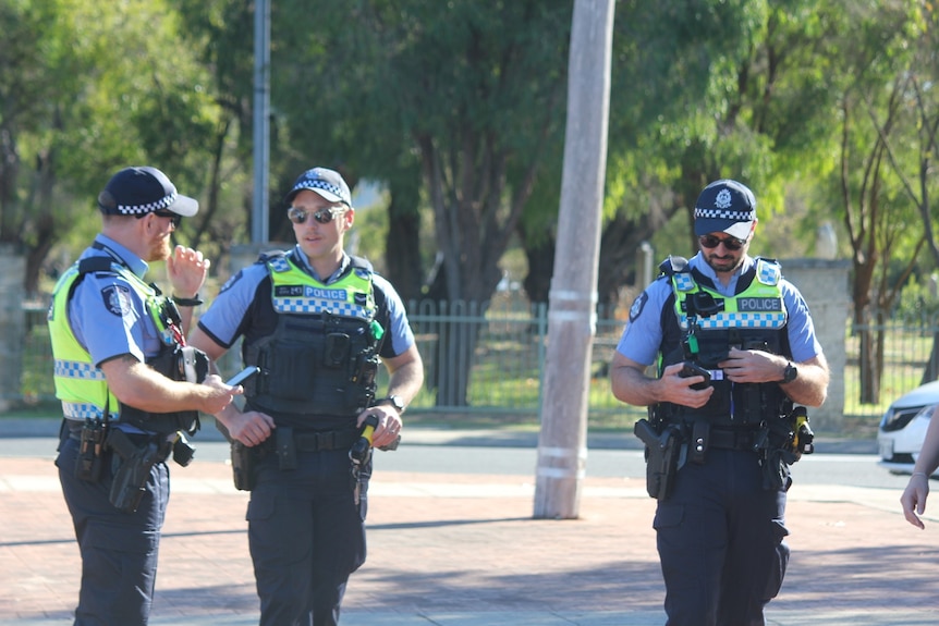 Police officers stand outside Busselton Courthouse.