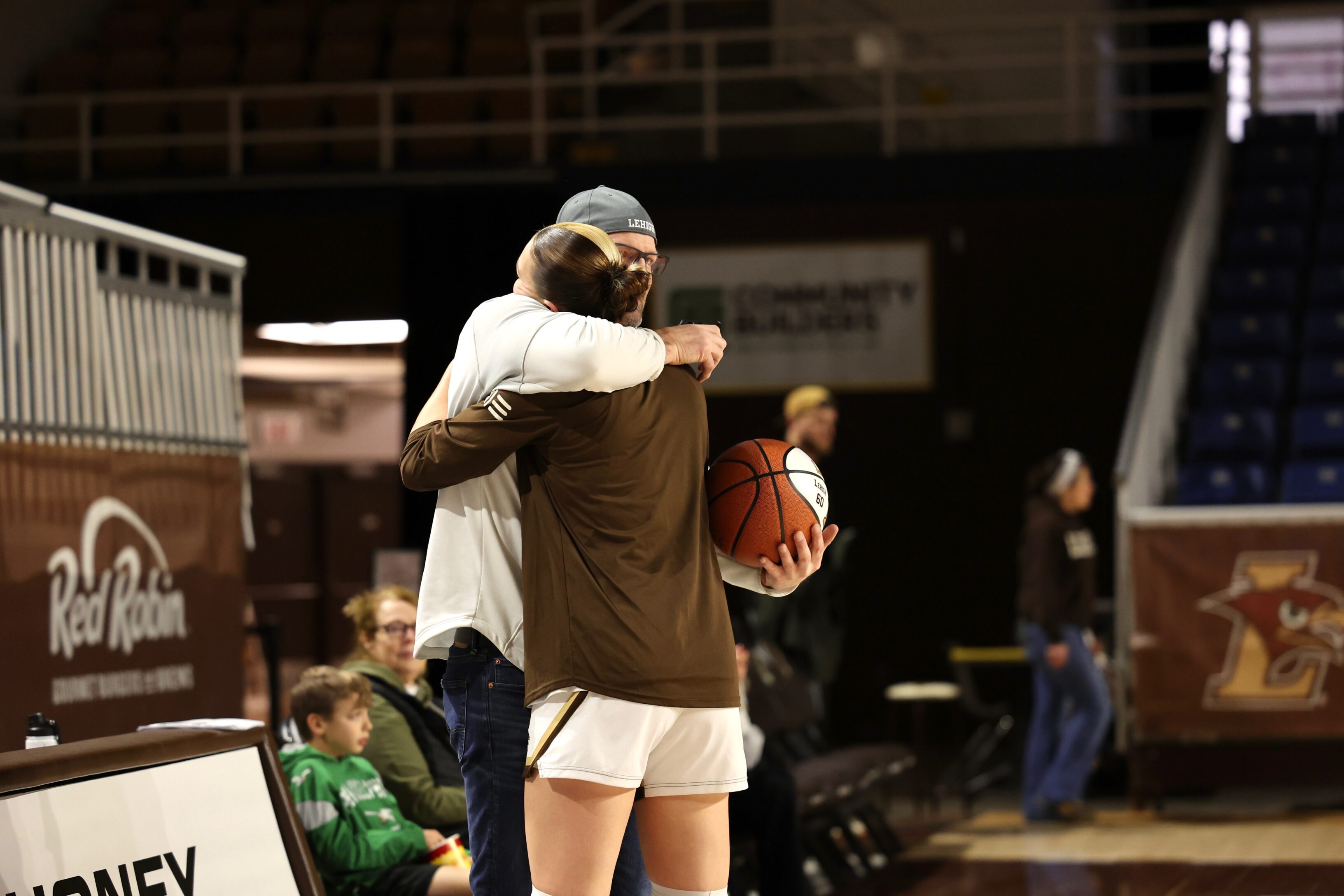 Lehigh women's basketball forward Lily Fandre hugs her father Clay Fandre.