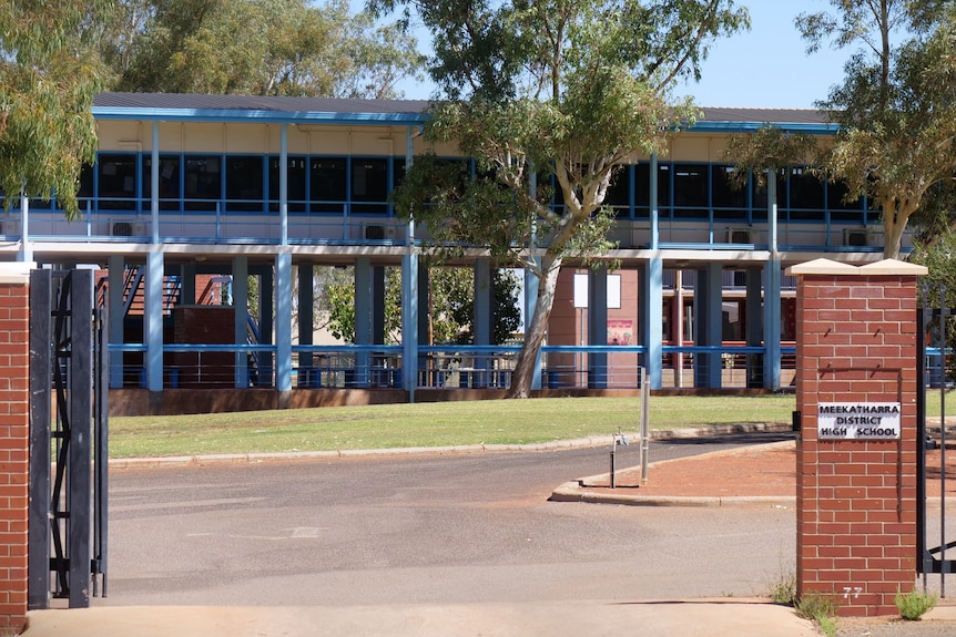 An empty school framed by a gate