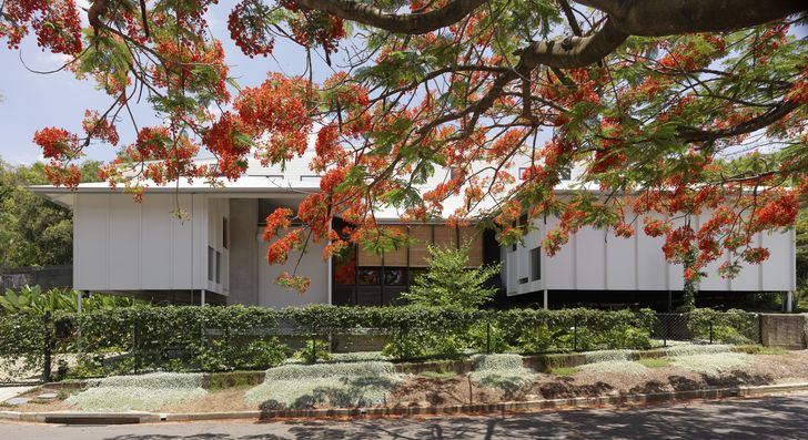The elevated sleeping pavilions of Three House are bridged by a central living space.