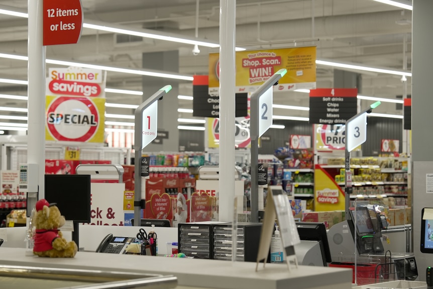 Close up of registers and special signs inside a Coles supermarket.
