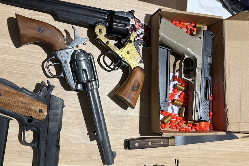 Guns on a table.