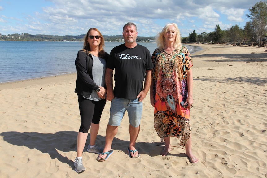 three people on a beach