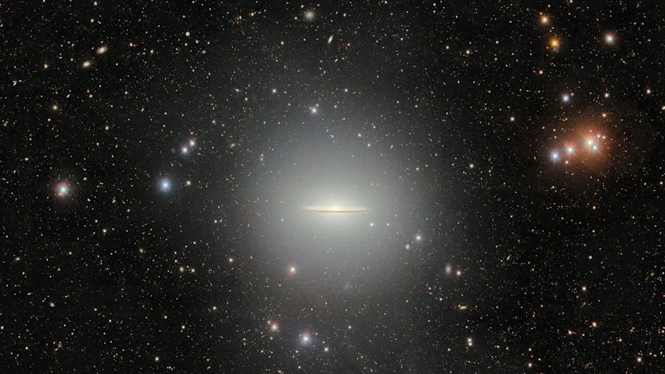 A flat disk of glowing light is seen against a starry background in space. .