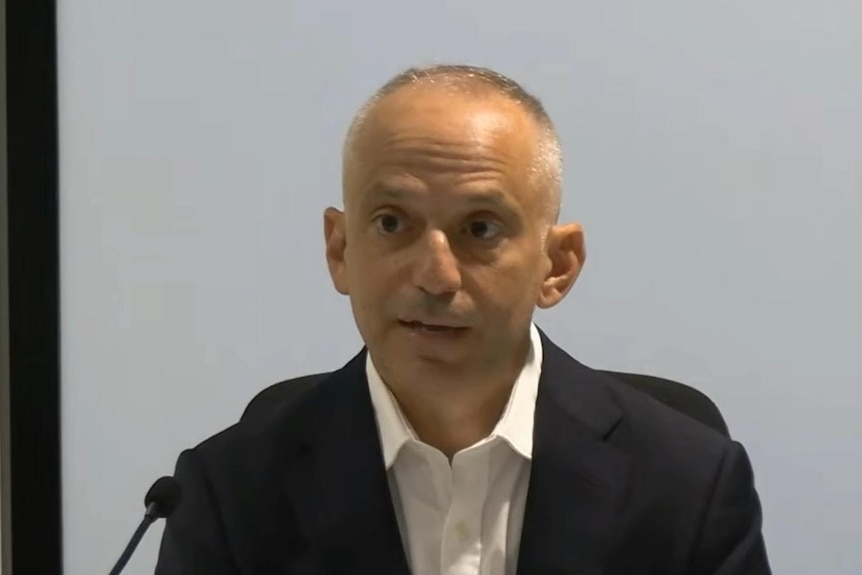 Man speaks into microphone