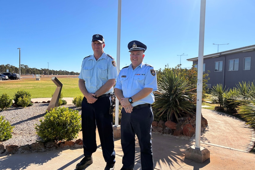 two correctional officers standing outside correctional centre