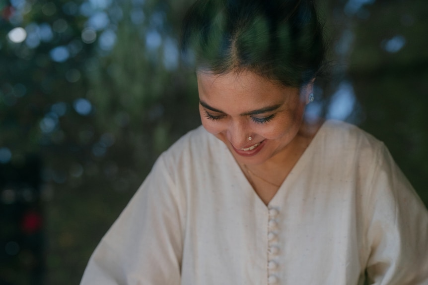 Kishwar Chowdhury in a white dress preparing food.