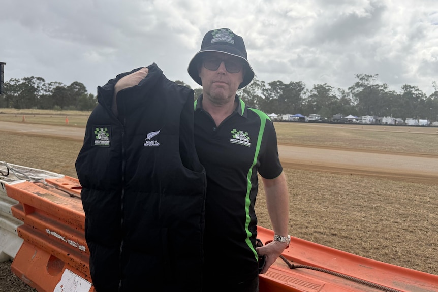 A man holding a jacket.