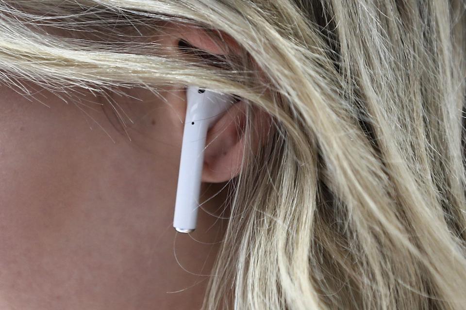 An attendee wears an Apple AirPod during a launch event on 7 September, 2016 in San Francisco, California (Stephen Lam/Getty Images)