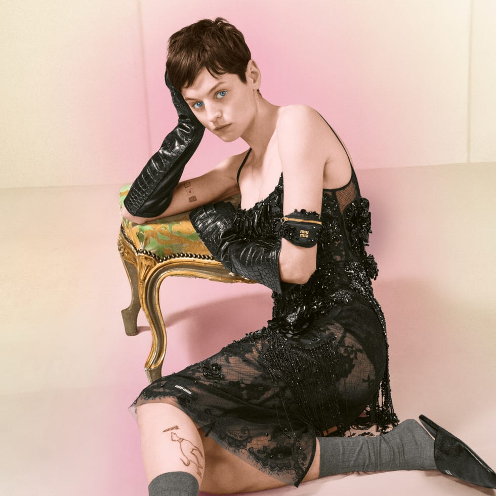 Fashion model posing in an elegant dress with accessories.