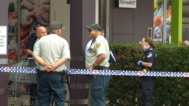 Police, investigators and Armaguard security guards at Eli Waters Shopping Centre following the alleged heist.