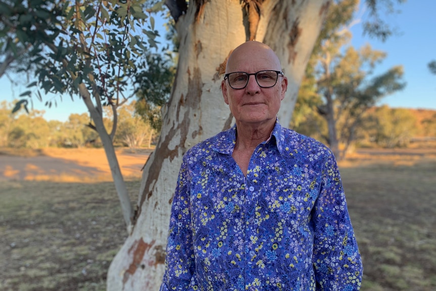 John Boffa stands in front of a tree.
