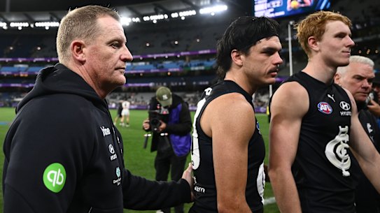 Voss and Hollands (centre) leave the MCG after the loss to Collingwood on April 16.