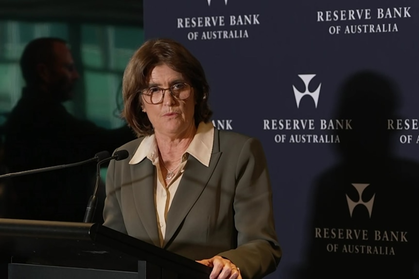 Bullocks, wearing a brown jacket, speaks at a press conference