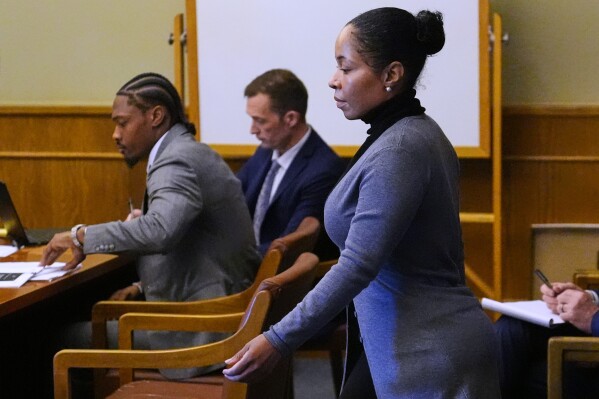 Witness Jamila Adams, right, walks past former New England Patriots wide receiver Stefon Diggs during Diggs' trial at Norfolk County District Court, Tuesday, May 5, 2026, in Dedham, Mass. (AP Photo/Charles Krupa, Pool)