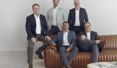 Five members of the board of Bennett and Bennett Holdings sitting and leaning against a couch