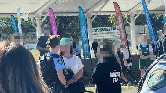 Police talk to a mother at Heffron Park on Saturday, May 11, after her alleged antisemitic outburst at an under 12s netball game.