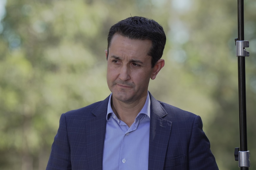 Queensland premier David Crisafulli in a blue suit outdoors