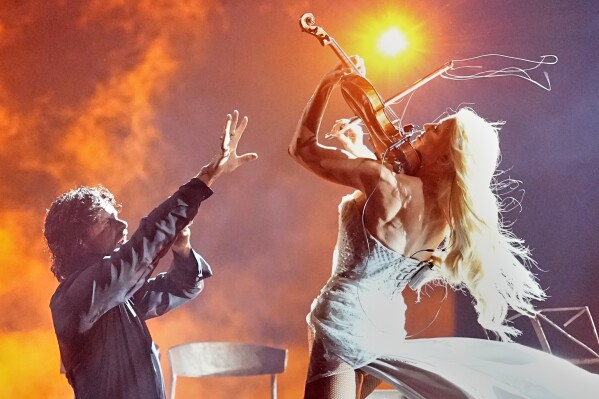 Linda Lampenius and Pete Parkkonen from Finland perform the song "Liekinheitin" during the Grand Final of the 70th Eurovision Song Contest in Vienna, Austria, Saturday, May 16, 2026. (AP Photo/Martin Meissner)