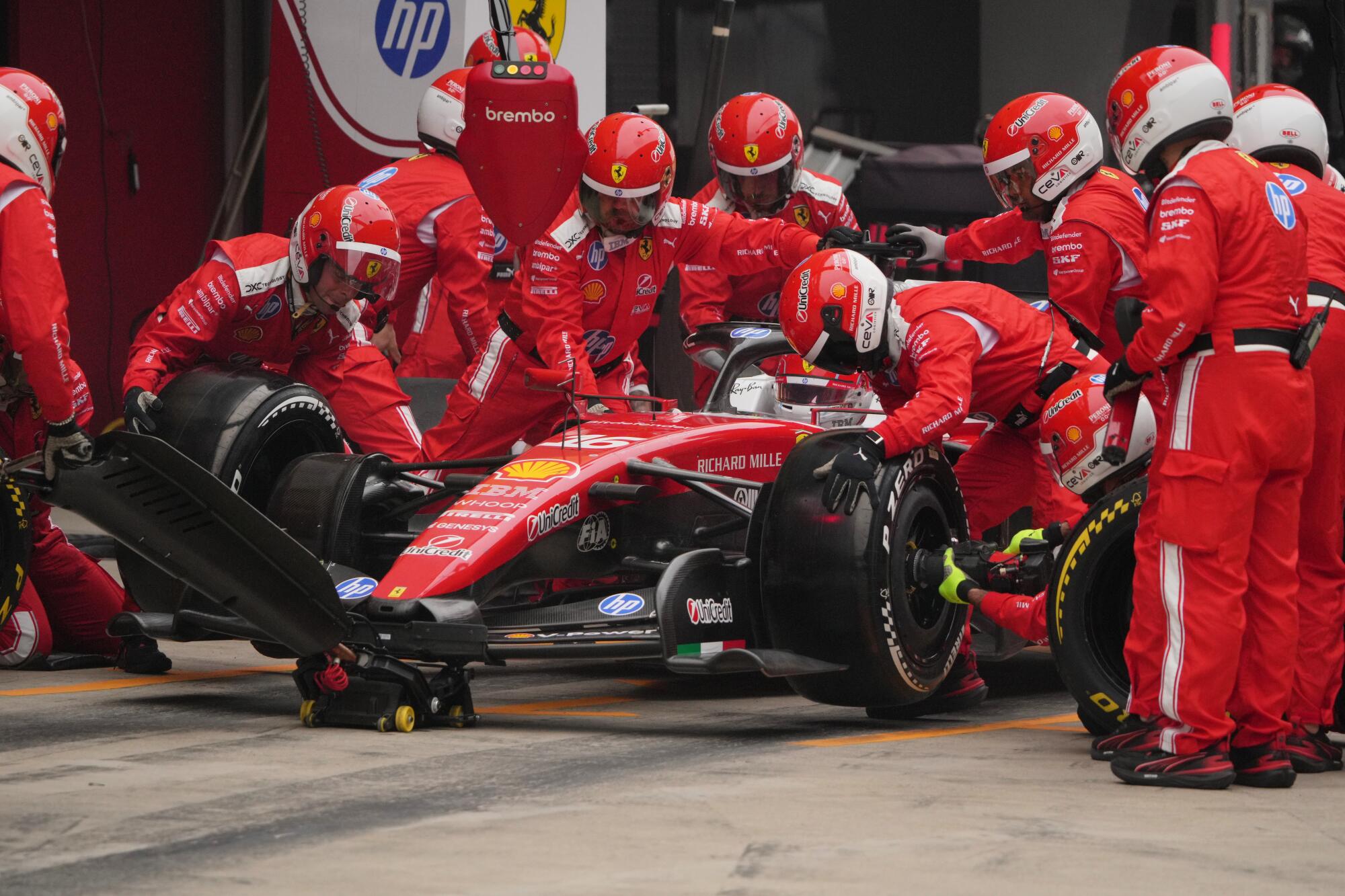 Ferrari driver Charles Leclerc makes a pit stop for new tires during the Chinese Grand Prix on March 15.