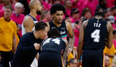 San Antonio Spurs head coach Mitch Johnson, from left, talks to guard Devin Vassell (24), guard Dylan Harper (2) and guard De'aaron Fox (4) during the fourth quarter of Game 1 of the Western Conference semifinals against the Minnesota Timberwolves at Frost Bank Center in San Antonio, Monday, May 4, 2026. The Spurs could be without both Harper and Fox in Game 3 of the Western Conference finals against the Oklahoma City Thunder on Friday. Fox has missed the first two games of the series with a right ankle sprain, while Harper left Game 2 early and didn't return. Both are listed as questionable.