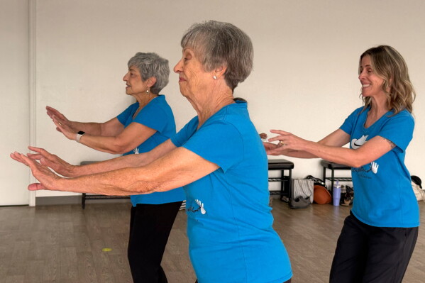 Cindy Soffrin, from left, Carol Ross, and Suzy Rhoades, of The Rodeo City Wreckettes, a tap and jazz dance group for older women, practice on Thursday, April 16, 2026, in Tucson, Ariz. (Anita Snow via AP)