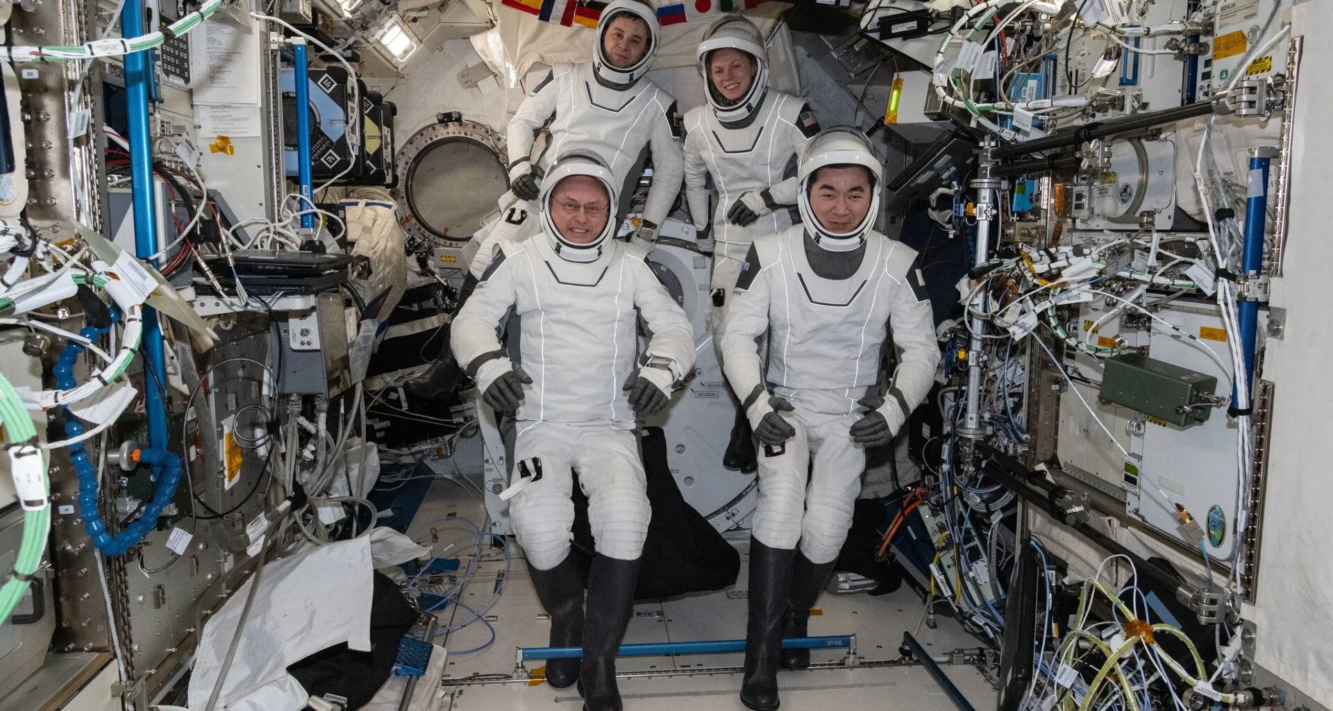 NASA's SpaceX Crew-11 astronauts gather together for a crew portrait wearing their Dragon pressure suits during a suit verification check inside the International Space Station's Kibo laboratory module. Clockwise from bottom left are, NASA astronaut Mike Fincke, Roscosmos cosmonaut Oleg Platonov, NASA astronaut Zena Cardman, and JAXA (Japan Aerospace Exploration Agency) astronaut Kimiya Yui.