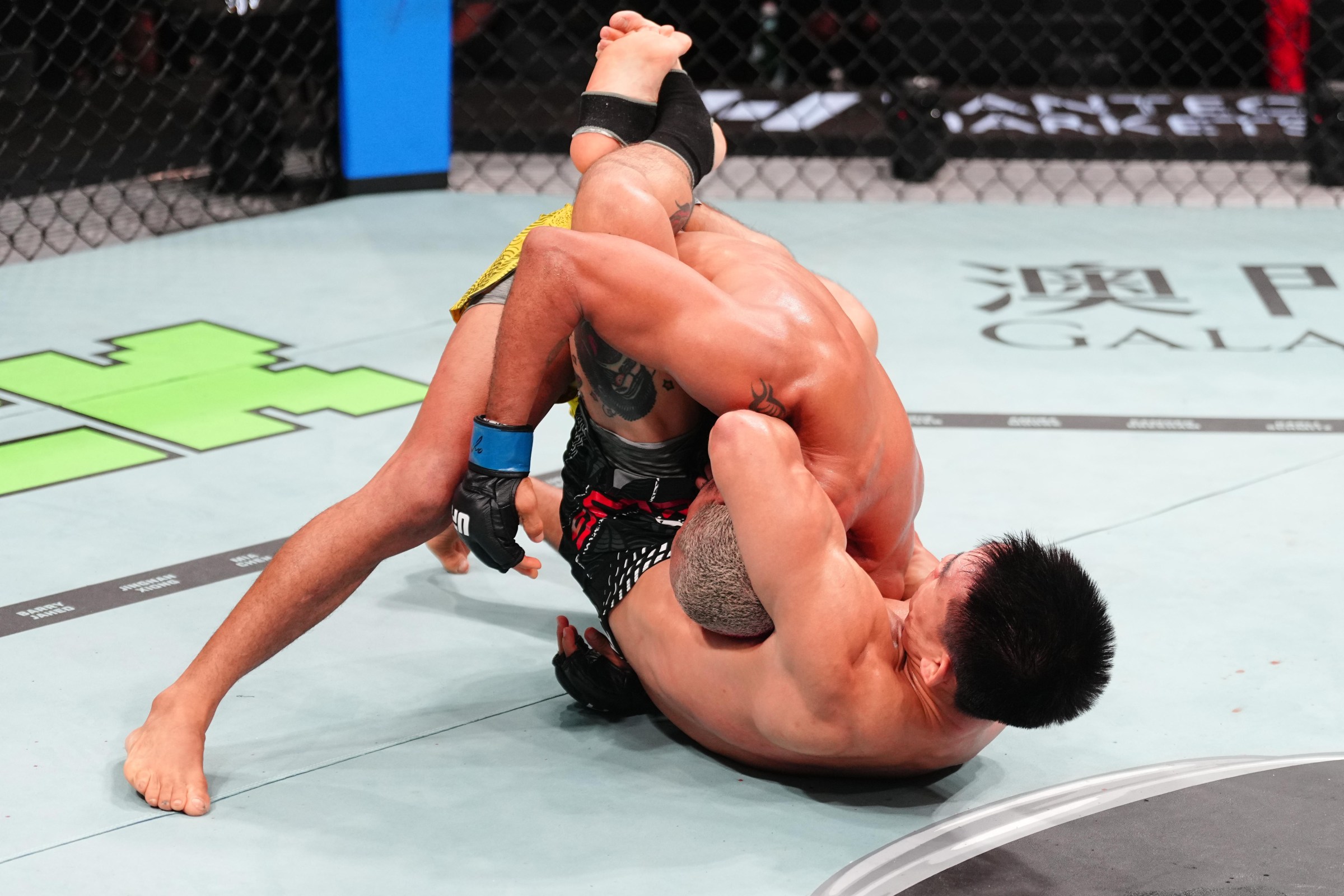 MACAU, CHINA - MAY 30: Song Yadong of China secures a submission against Deiveson Figueiredo of Brazil in a bantamweight fight during the UFC Fight Night event at Galaxy Arena on May 30, 2026 in Macau, China. (Photo by Jeff Bottari/Zuffa LLC)