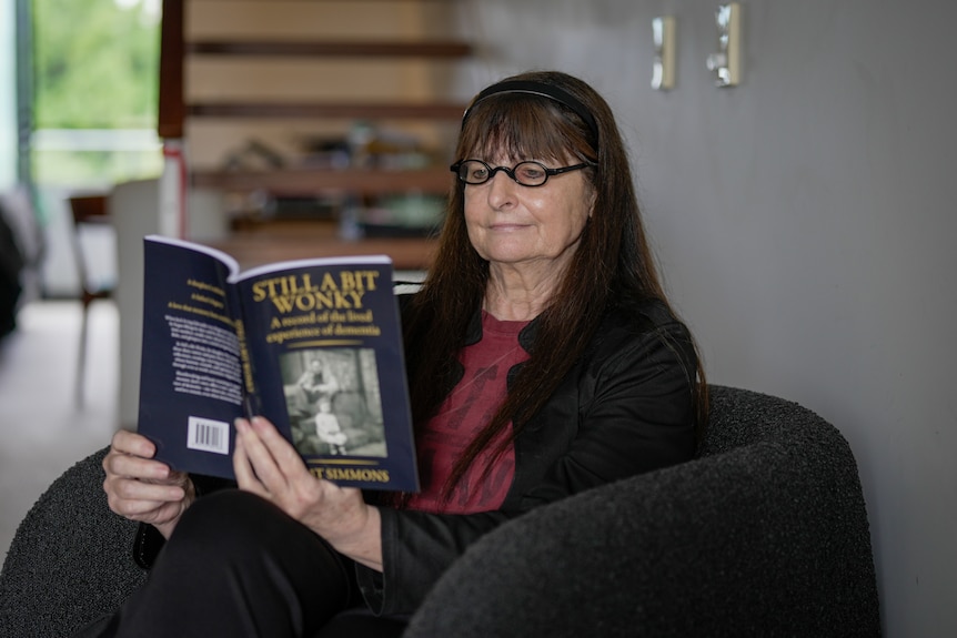 Jane Turner sits on a chair reading a book