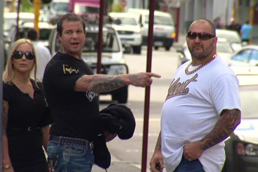 David Pye points towards Rebels president Nick Martin as the pair leave court in Perth's CBD.