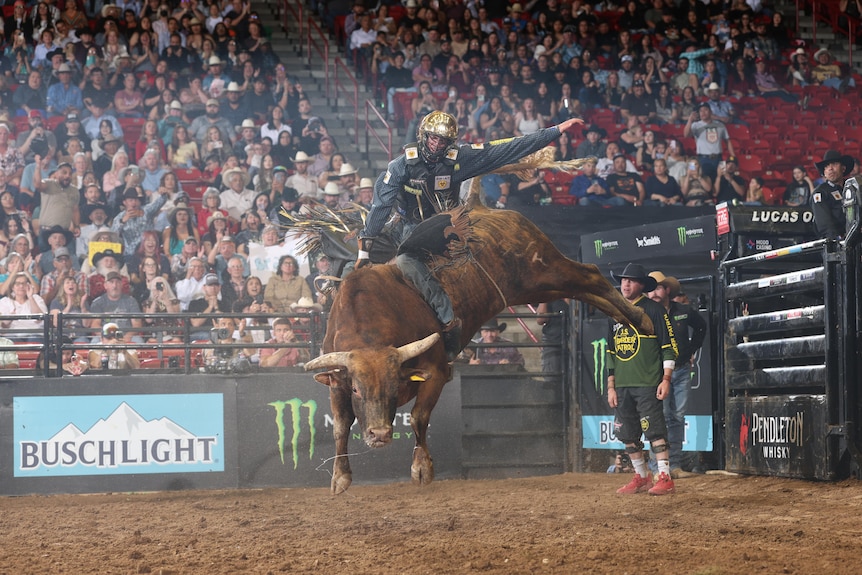 Brady Fielder trying to hang on to a bucking bull.