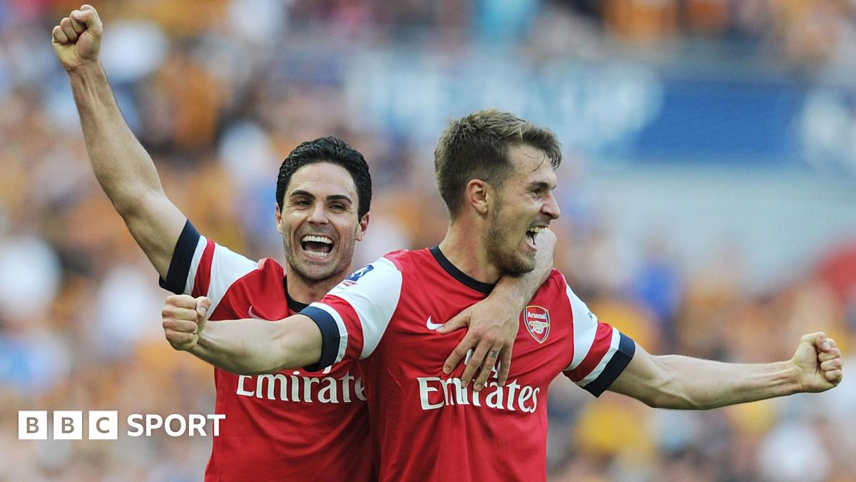 Aaron Ramsey and Mikel Arteta celebrate at the final whistle after the FA Cup final between Arsenal and Hull City at Wembley Stadium in 2014
