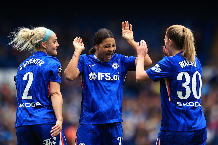 Sam Kerr high fives Chelsea teammates Ellie Carpenter and Keira Walsh.